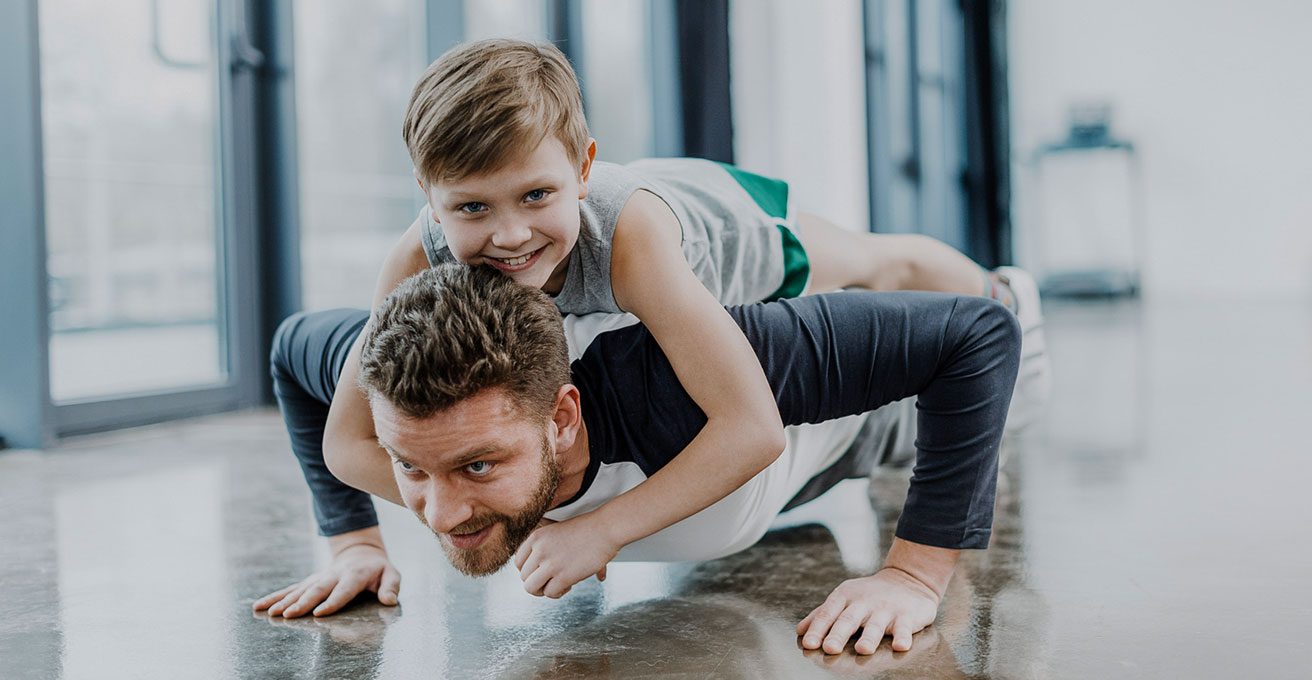 man at westchase chiropractic exercising with son